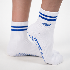 Just Keep Swimming grip socks by PikeFit: white crew sock with blue stripes and an embroidered fish